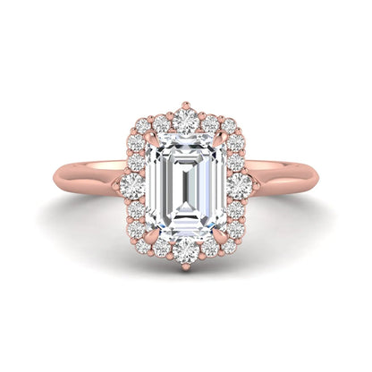 Emerald cut lab grown diamond halo engagement ring with round accent diamonds in a rose gold tone four-prong setting.