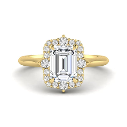 Emerald cut lab grown diamond halo engagement ring with round accent diamonds in a yellow gold tone four-prong setting.