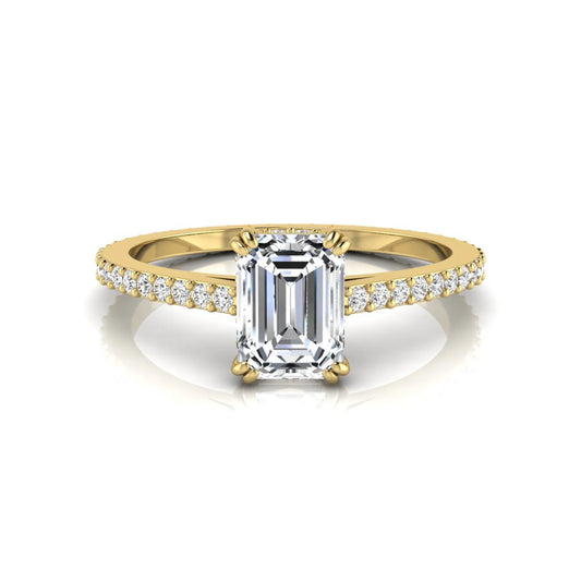Emerald cut lab grown diamond engagement ring with hidden halo, pavé band, and four-prong setting in yellow gold tone design