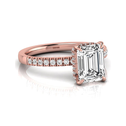 Emerald cut lab grown diamond engagement ring featuring a hidden halo, pavé diamond band, and four-prong setting in rose gold tone.