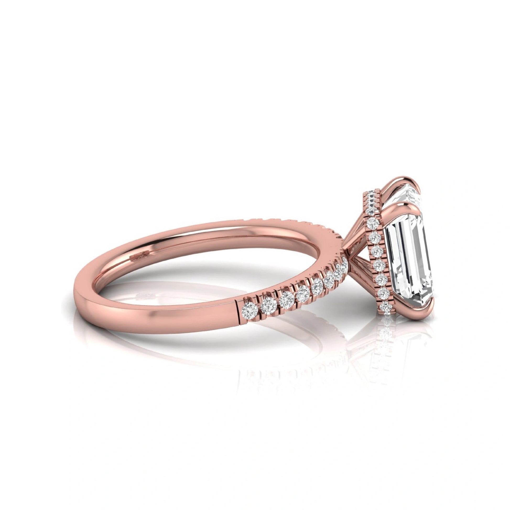 Emerald cut lab grown diamond engagement ring featuring a hidden halo, pavé diamond band, and four-prong setting in rose gold tone.