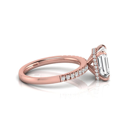 Emerald cut lab grown diamond engagement ring featuring a hidden halo, pavé diamond band, and four-prong setting in rose gold tone.