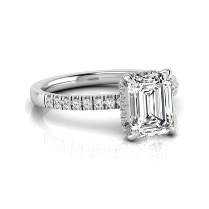 Emerald cut lab grown diamond engagement ring featuring a hidden halo, pavé diamond band, and four-prong setting in white gold tone.
