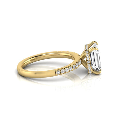 Emerald cut lab grown diamond engagement ring featuring a hidden halo, pavé diamond band, and four-prong setting in yellow gold tone.
