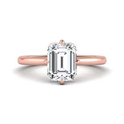 Emerald cut lab grown diamond hidden halo solitaire engagement ring featuring a four-prong setting on a polished rose gold band.