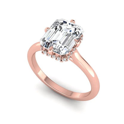 Emerald cut lab grown diamond hidden halo solitaire engagement ring featuring a four-prong setting on a polished rose gold band.