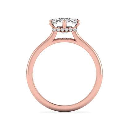 Emerald cut lab grown diamond hidden halo solitaire engagement ring featuring a four-prong setting on a polished rose gold band.