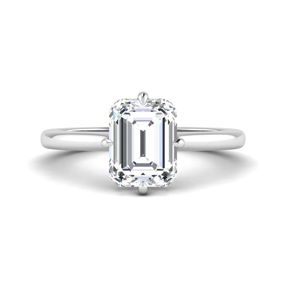 Emerald cut lab grown diamond hidden halo solitaire engagement ring featuring a four-prong setting on a polished white gold band.