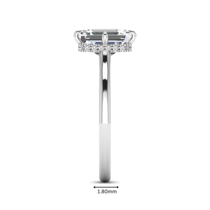 Emerald cut lab grown diamond hidden halo solitaire engagement ring featuring a four-prong setting on a polished white gold band.