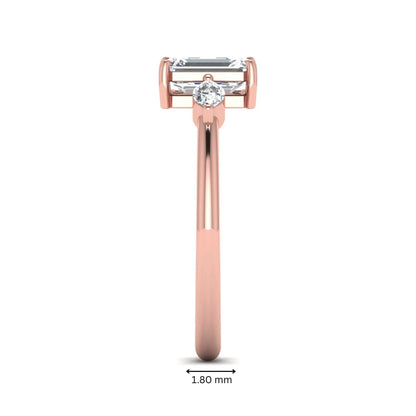 Emerald cut three stone lab grown diamond engagement ring featuring a 1.06 carat IGI certified center diamond with marquise side diamonds in rose gold.