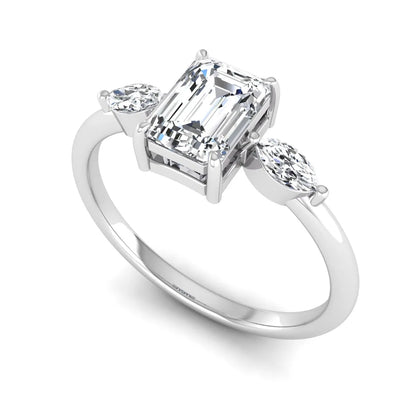 Emerald cut three stone lab grown diamond engagement ring featuring a 1.06 carat IGI certified center diamond with marquise side diamonds in white gold.