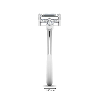 Emerald cut three stone lab grown diamond engagement ring featuring a 1.06 carat IGI certified center diamond with marquise side diamonds in white gold.