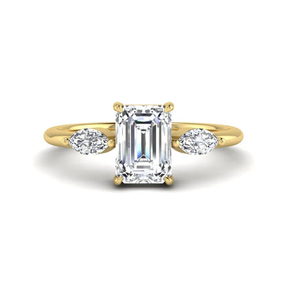 Emerald cut three stone lab grown diamond engagement ring featuring a 1.06 carat IGI certified center diamond with marquise side diamonds in yellow gold.
