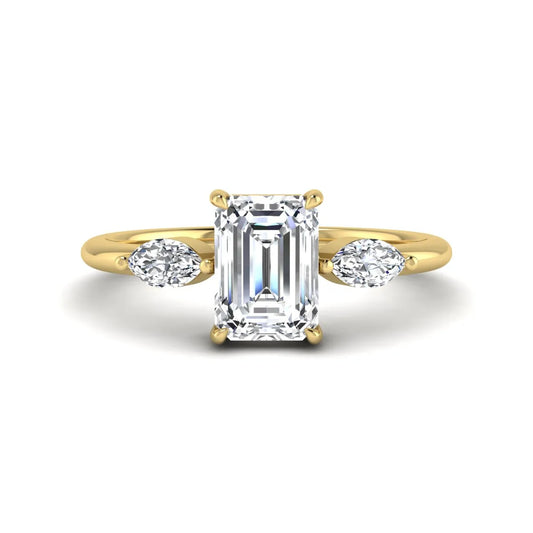 Emerald cut three stone lab grown diamond engagement ring featuring a 1.06 carat IGI certified center diamond with marquise side diamonds in yellow gold.