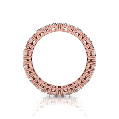 Emerald and oval cut lab grown diamond eternity band ring with alternating diamonds in a shared prong setting and rose gold style.