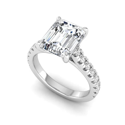 Emerald cut lab grown diamond engagement ring with pavé round diamonds in a white gold four-prong cathedral setting