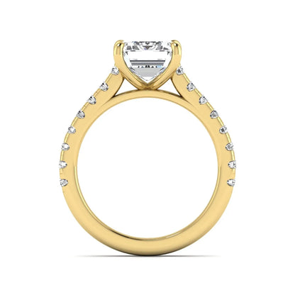 Emerald cut lab grown diamond engagement ring with pavé round diamonds in a yellow gold four-prong cathedral setting