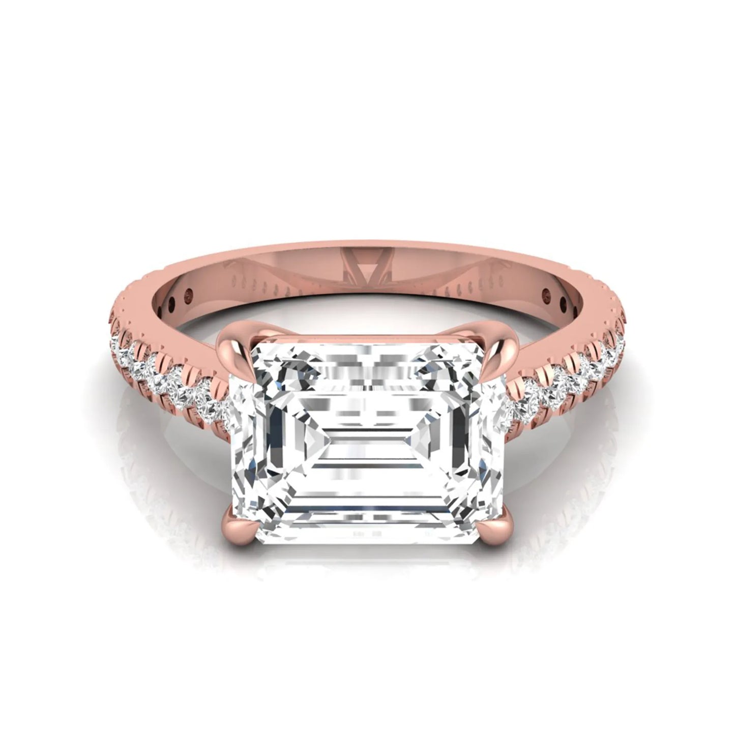 Emerald cut lab grown diamond solitaire engagement ring featuring a four-prong setting with a pavé diamond band in rose gold tone.