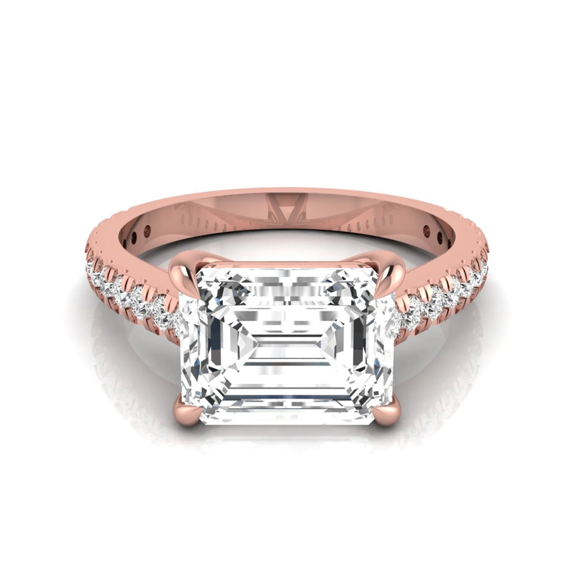 Emerald cut lab grown diamond solitaire engagement ring featuring a four-prong setting with a pavé diamond band in rose gold tone.