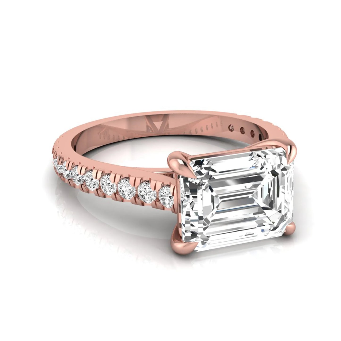 Emerald cut lab grown diamond solitaire engagement ring featuring a four-prong setting with a pavé diamond band in rose gold tone.
