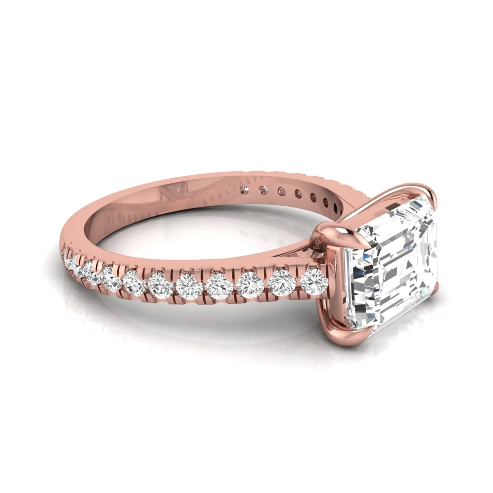 Emerald cut lab grown diamond solitaire engagement ring featuring a four-prong setting with a pavé diamond band in rose gold tone.