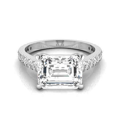 Emerald cut lab grown diamond solitaire engagement ring featuring a four-prong setting with a pavé diamond band in white gold tone.