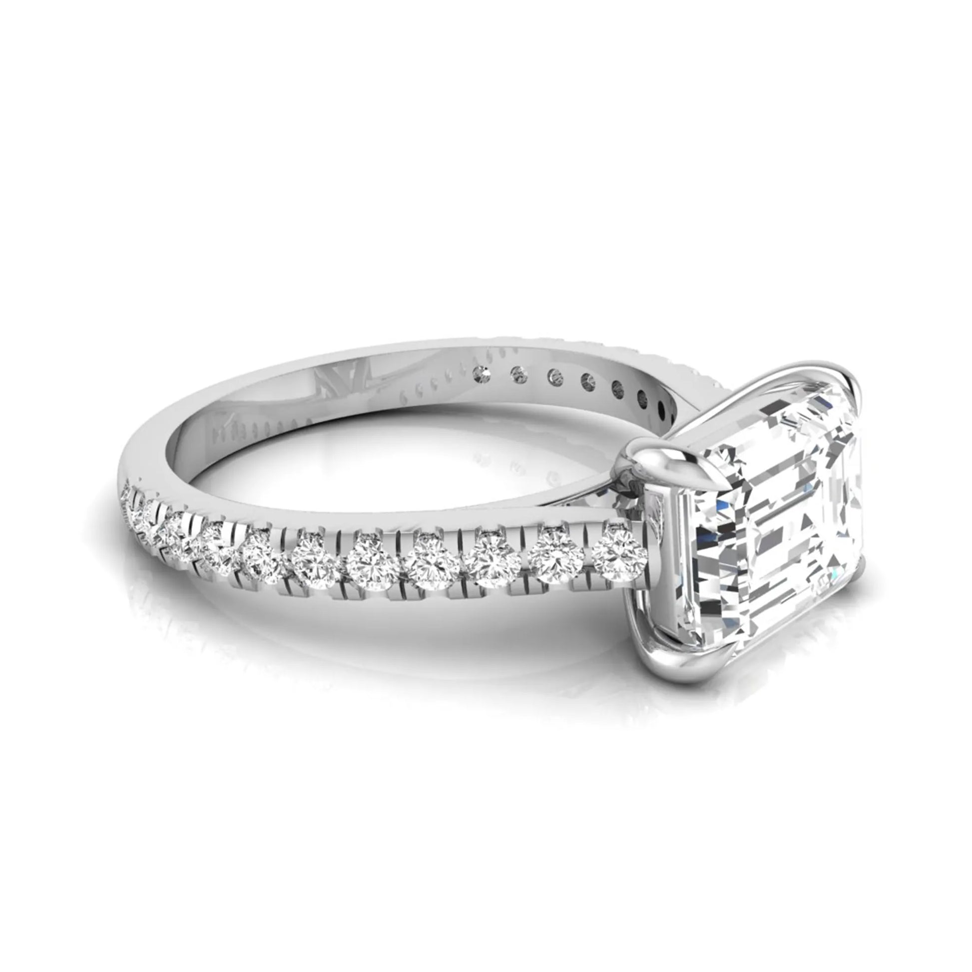 Emerald cut lab grown diamond solitaire engagement ring featuring a four-prong setting with a pavé diamond band in white gold tone.