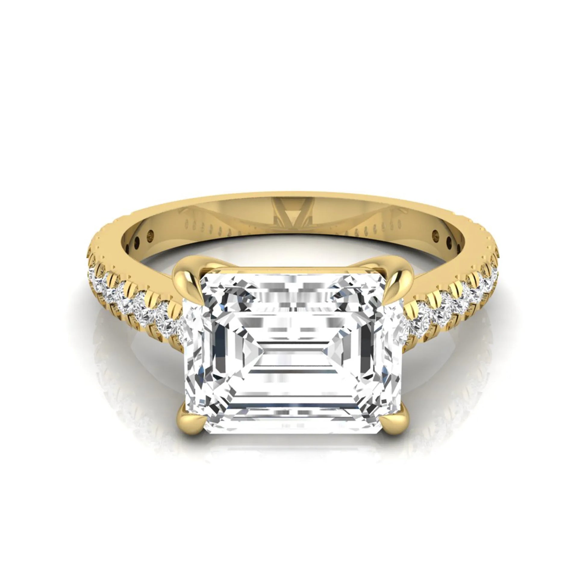 Emerald cut lab grown diamond solitaire engagement ring featuring a four-prong setting with a pavé diamond band in yellow gold tone.