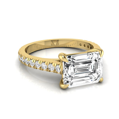 Emerald cut lab grown diamond solitaire engagement ring featuring a four-prong setting with a pavé diamond band in yellow gold tone.