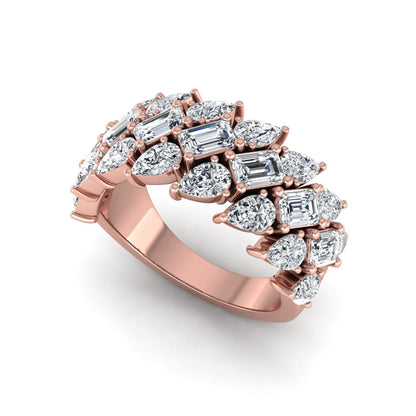 Emerald and pear cut lab grown diamond cluster ring with prong setting in rose gold tone wide band design.