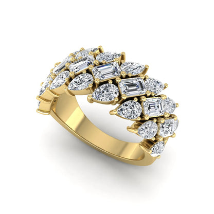 Emerald and pear cut lab grown diamond cluster ring with prong setting in yellow gold tone wide band design.