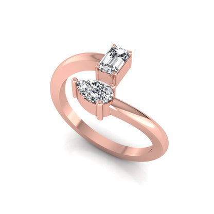 Emerald and pear cut lab grown diamond Toi et Moi ring featuring a minimalist open design in rose gold