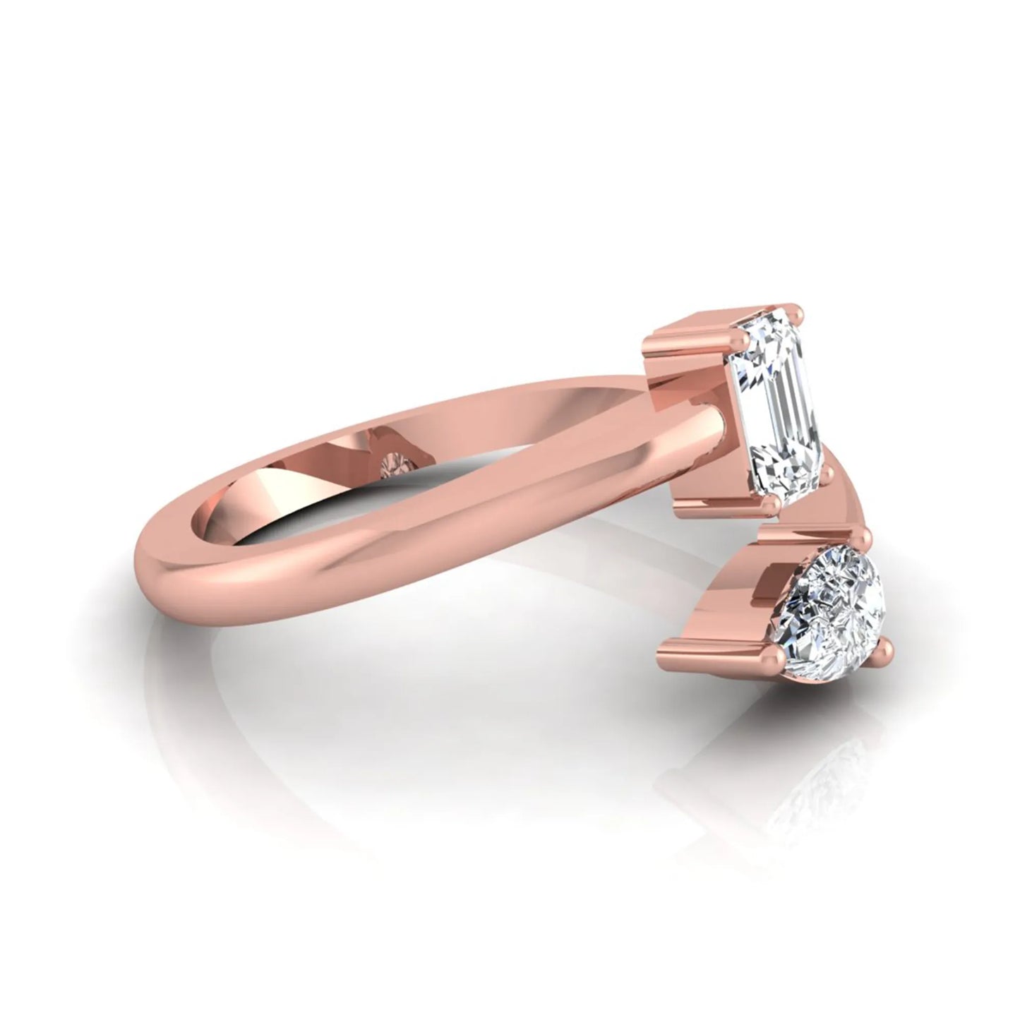 Emerald and pear cut lab grown diamond Toi et Moi ring featuring a minimalist open design in rose gold