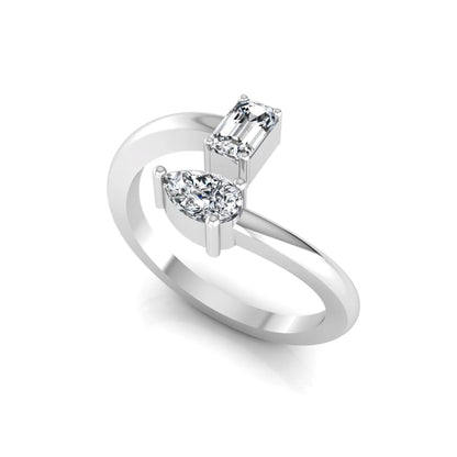 Emerald and pear cut lab grown diamond Toi et Moi ring featuring a minimalist open design in white gold