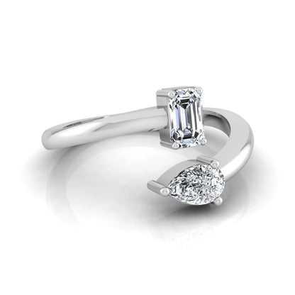 Emerald and pear cut lab grown diamond Toi et Moi ring featuring a minimalist open design in white gold