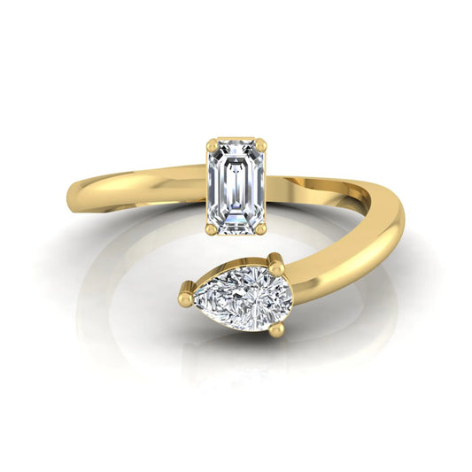 Emerald and pear cut lab grown diamond Toi et Moi ring featuring a minimalist open design in yellow gold