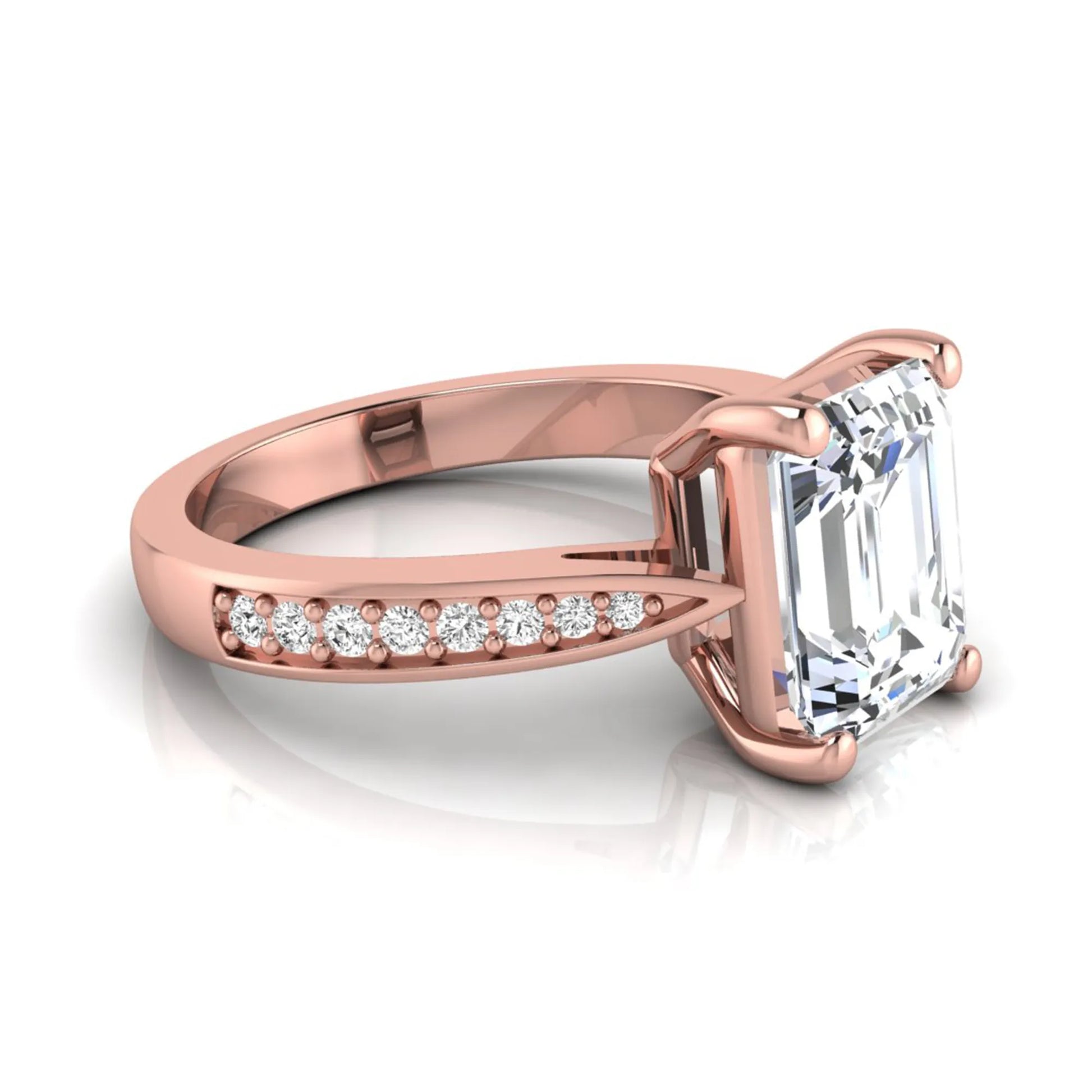 Emerald cut lab grown diamond engagement ring featuring a four-prong setting with round diamond accent band in a rose gold style design.