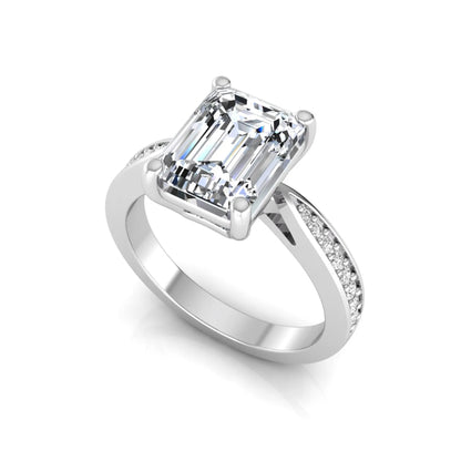Emerald cut lab grown diamond engagement ring featuring a four-prong setting with round diamond accent band in a white gold style design.