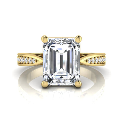 Emerald cut lab grown diamond engagement ring featuring a four-prong setting with round diamond accent band in a yellow gold style design.