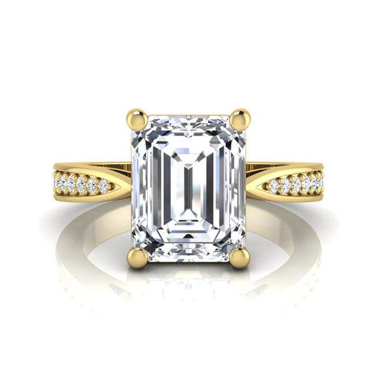 Emerald cut lab grown diamond engagement ring featuring a four-prong setting with round diamond accent band in a yellow gold style design.