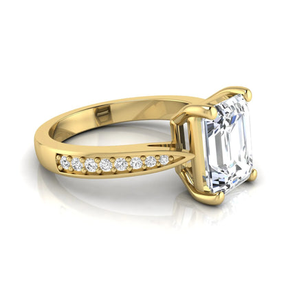 Emerald cut lab grown diamond engagement ring featuring a four-prong setting with round diamond accent band in a yellow gold style design.