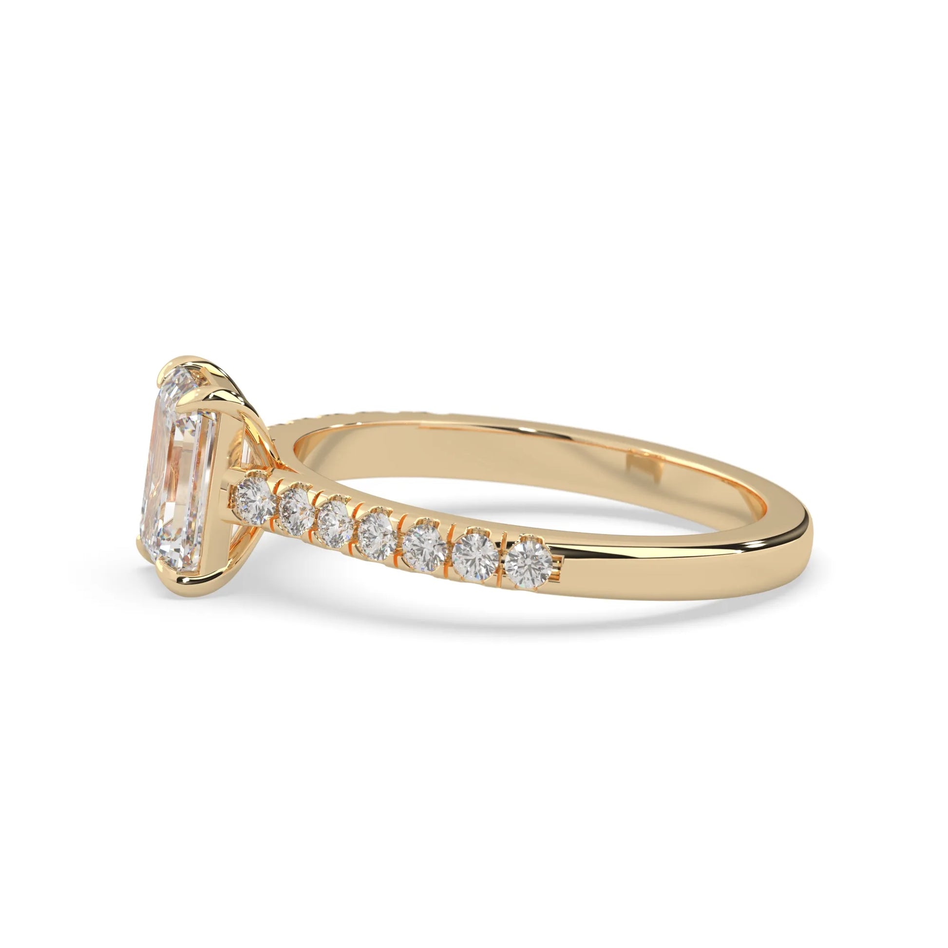 emerald cut lab grown diamond prong set engagement ring with pavé band and yellow gold  metal tone design