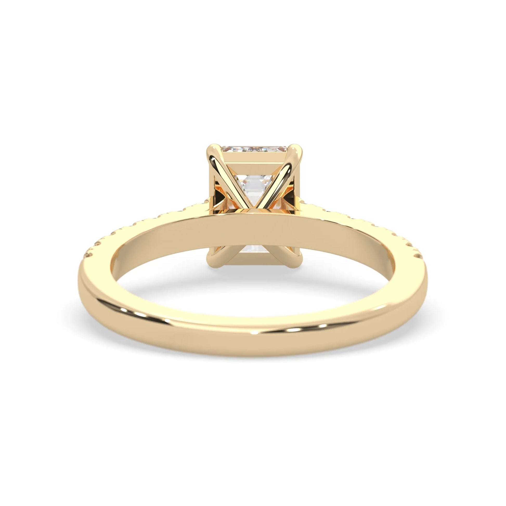 emerald cut lab grown diamond prong set engagement ring with pavé band and yellow gold  metal tone design