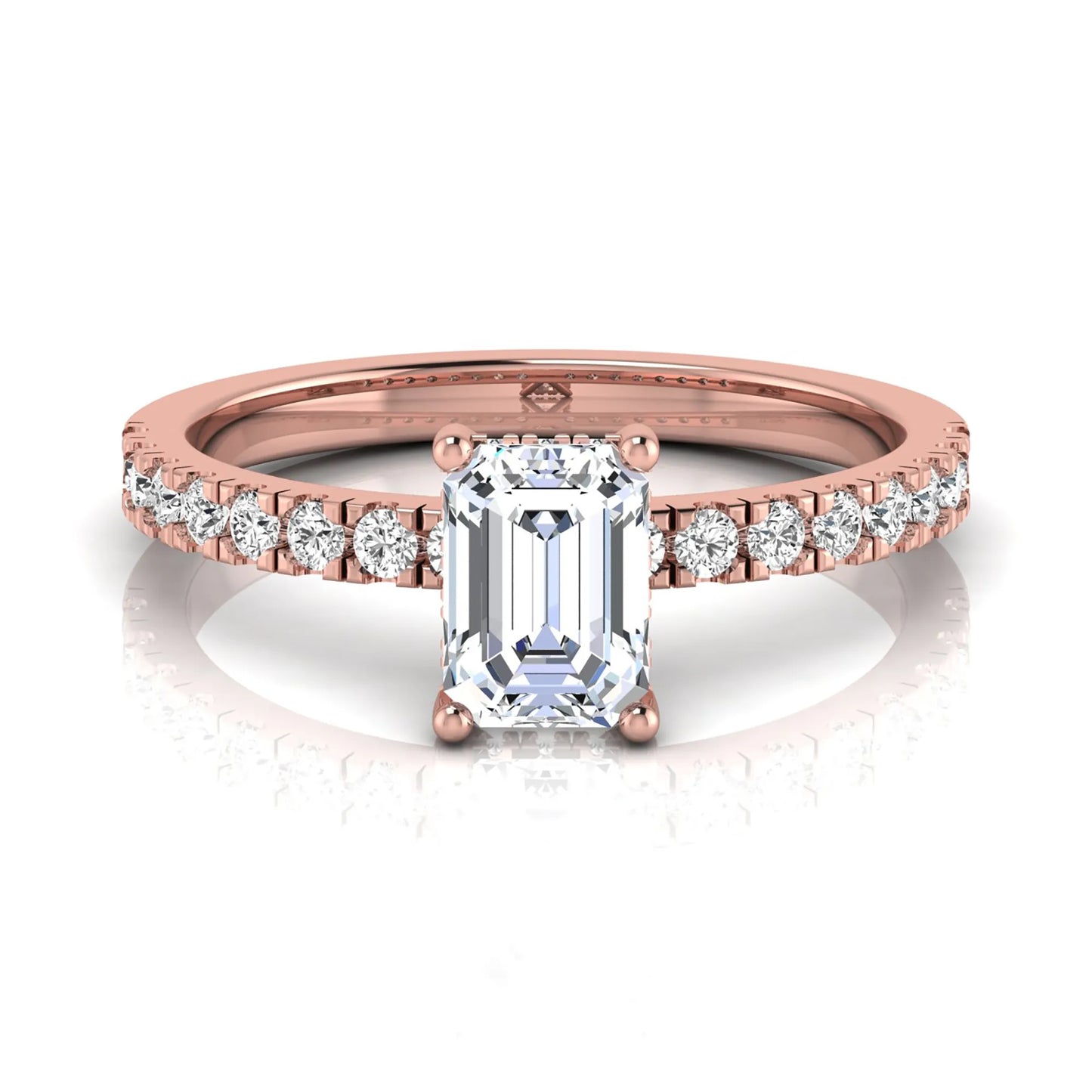 Emerald cut lab grown diamond solitaire ring with round pavé side stones in a four-prong setting and polished rose gold finish.
