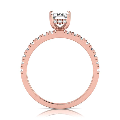 Emerald cut lab grown diamond solitaire ring with round pavé side stones in a four-prong setting and polished rose gold finish.