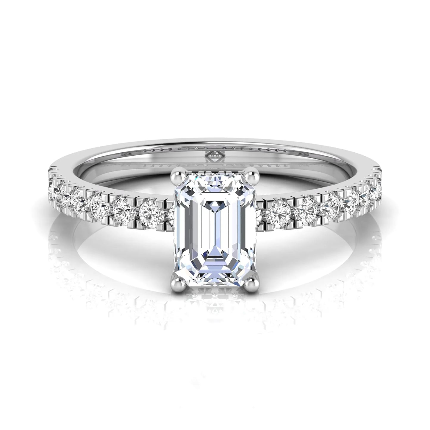 Emerald cut lab grown diamond solitaire ring with round pavé side stones in a four-prong setting and polished white gold finish.