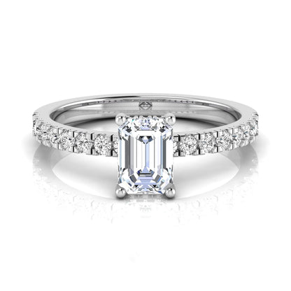 Emerald cut lab grown diamond solitaire ring with round pavé side stones in a four-prong setting and polished white gold finish.