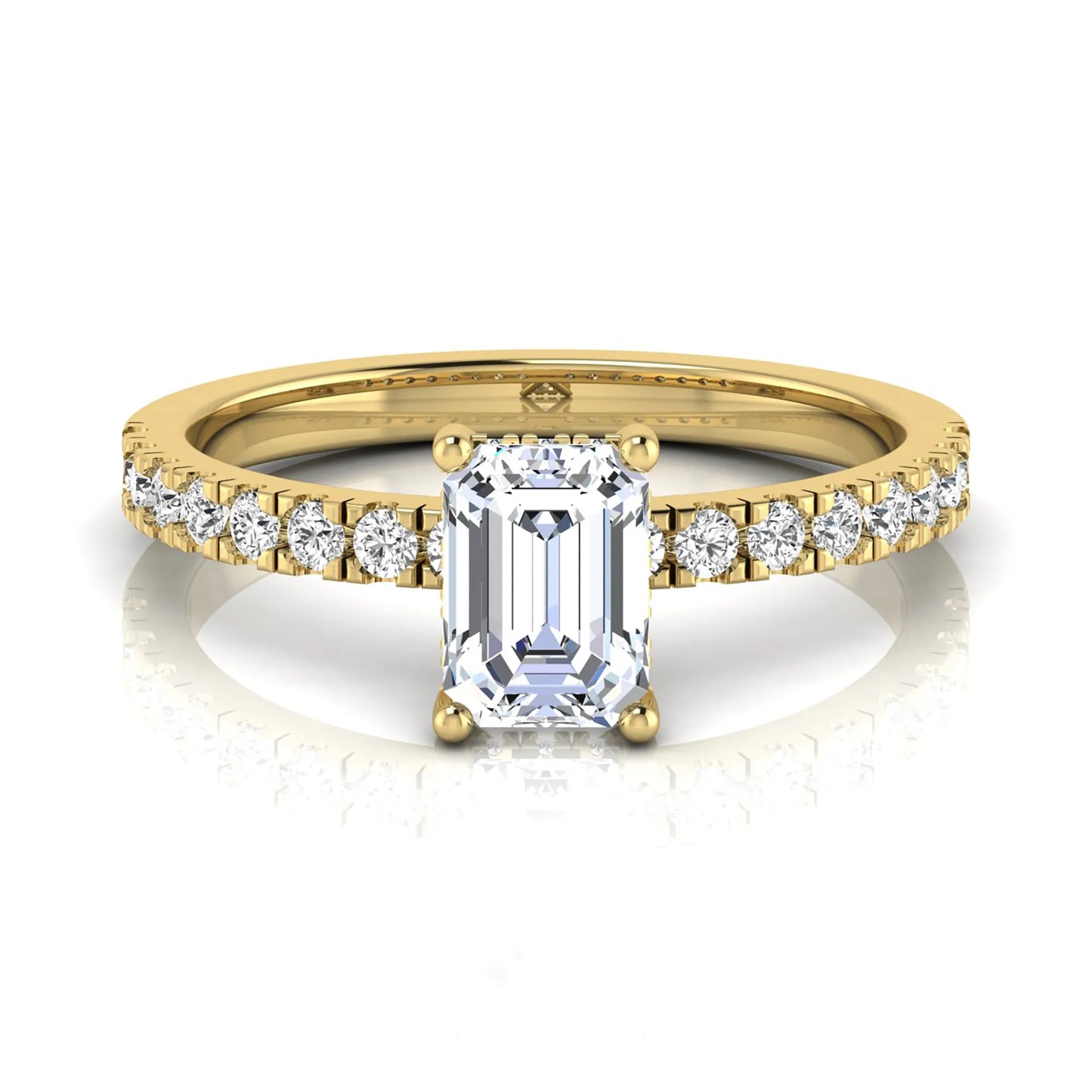 Emerald cut lab grown diamond solitaire ring with round pavé side stones in a four-prong setting and polished yellow gold finish.