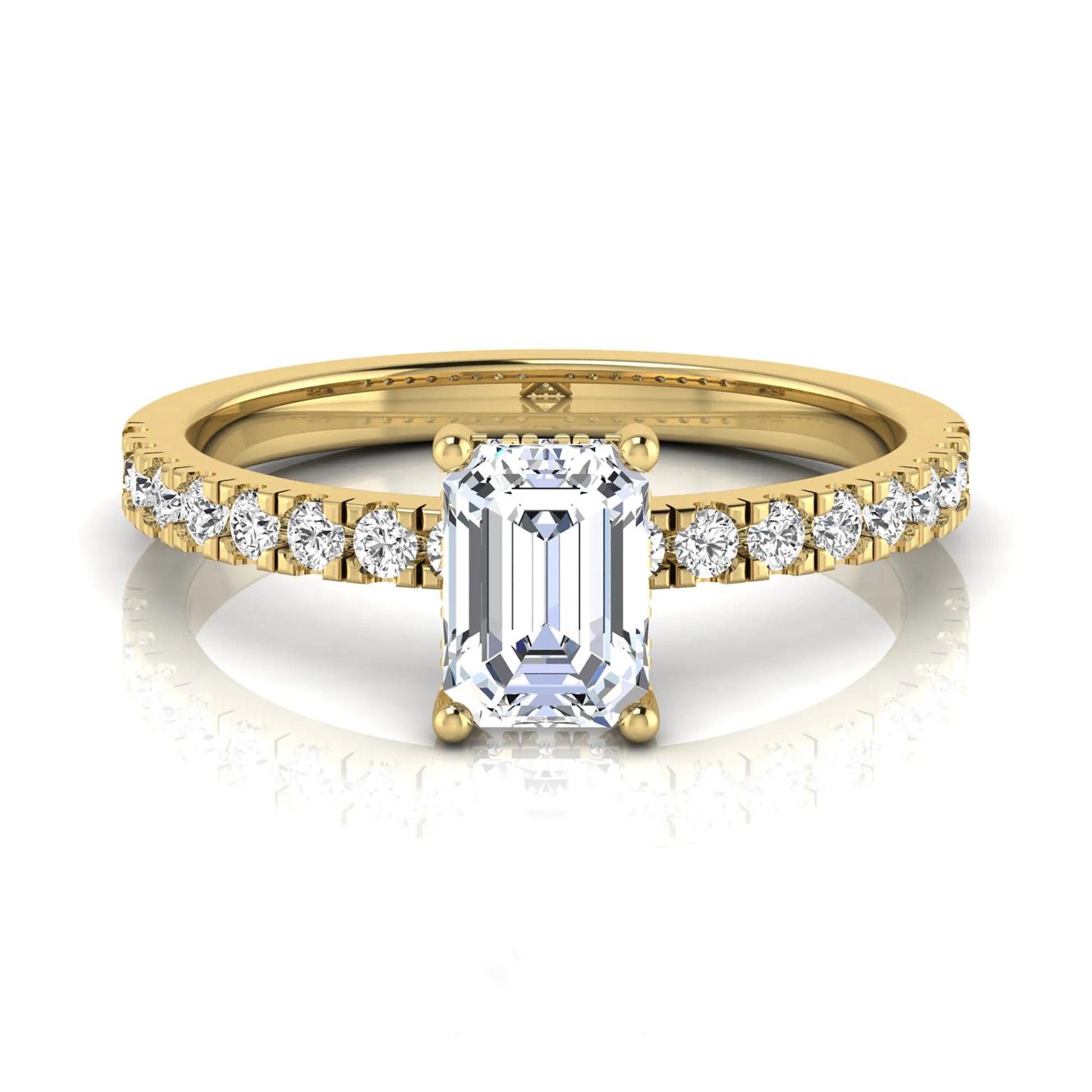 Emerald cut lab grown diamond solitaire ring with round pavé side stones in a four-prong setting and polished yellow gold finish.