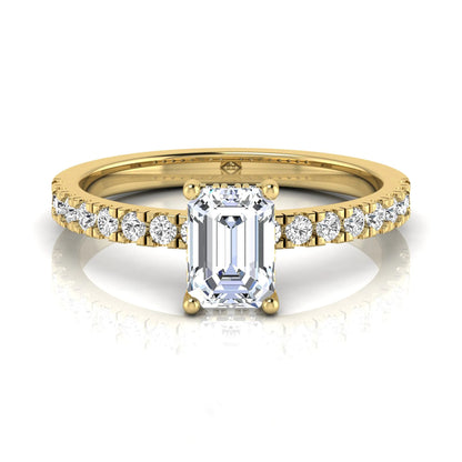 Emerald cut lab grown diamond solitaire ring with round pavé side stones in a four-prong setting and polished yellow gold finish.